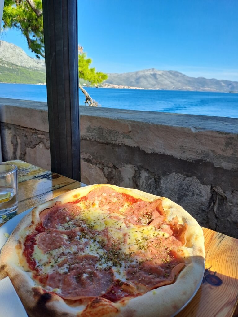 Eating pizza with a sea view on Korcula island in Croatia