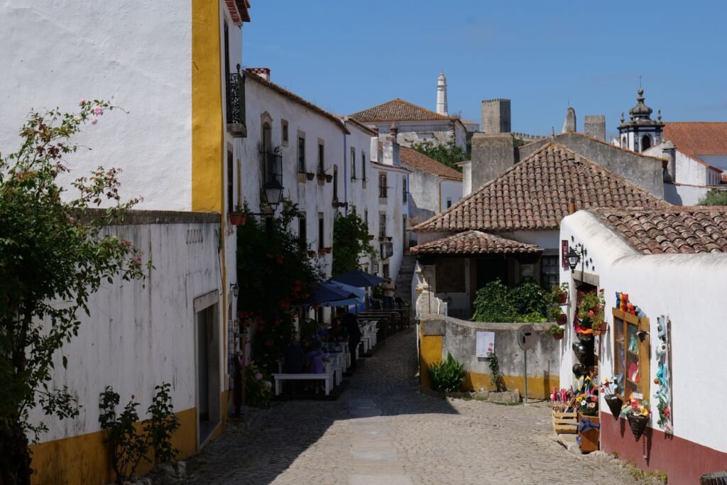 Exploring the charming, white-washed streets of Obidos on one of the best day trips from Lisbon!