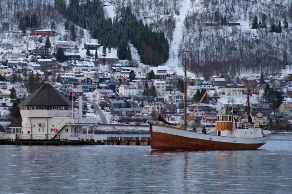 Watching the boats sail in and out of a snowy Tromsø harbour!