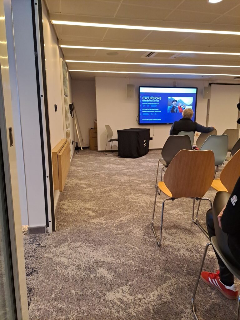 Attending a daily briefing in the conference room, led by the expedition team