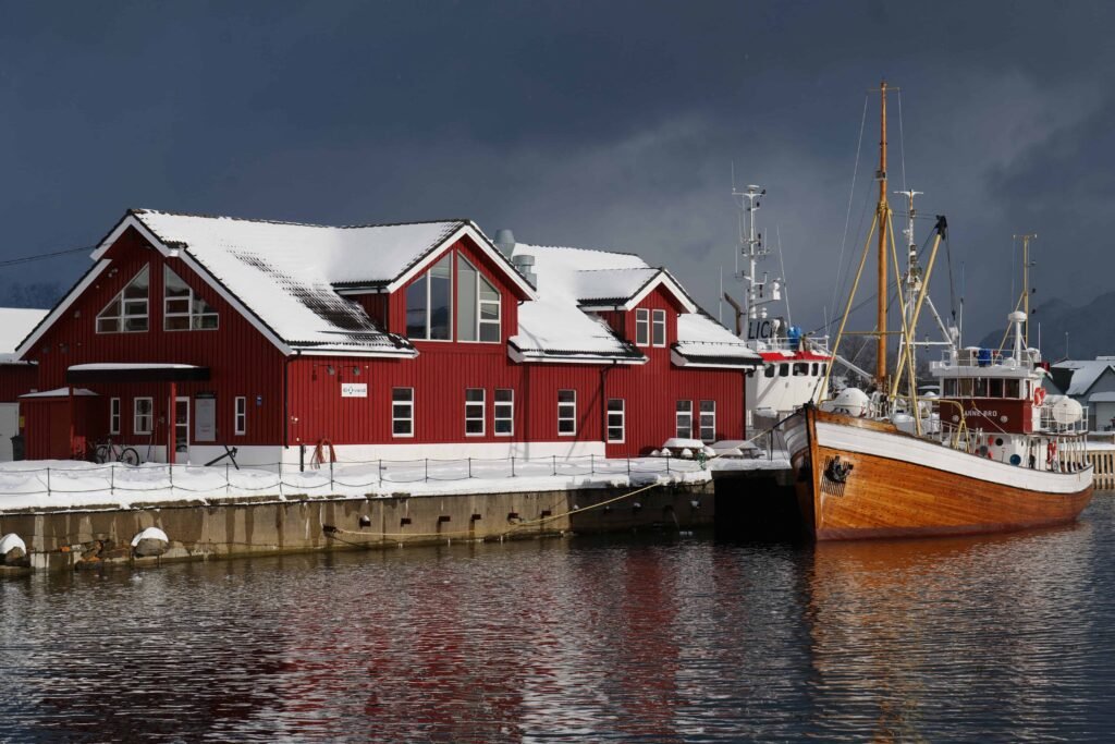 A moody, snowy day exploring Svolvaer's beautiful harbour is one of the best things to do in Svolvaer Norway!