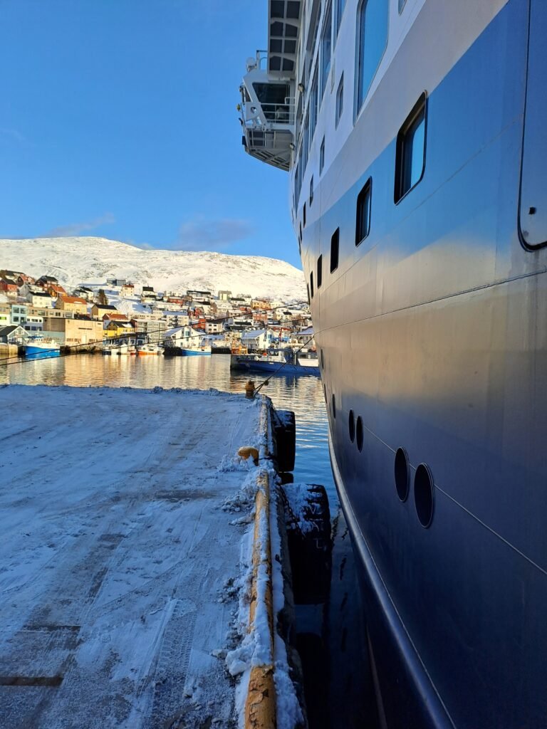 Havila voyages docked in snowy Honningsvåg 