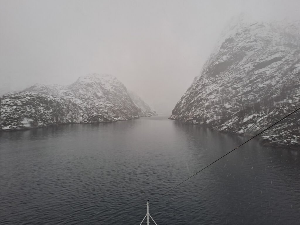 The entrance to Trollfjord in a snowstorm, taken from the Coastal Express