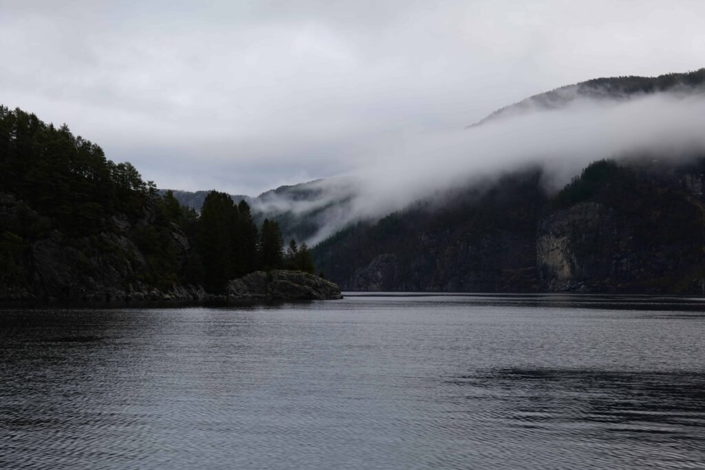 Low-lying mist blanketing the picturesque Mostraumen Fjord in winter