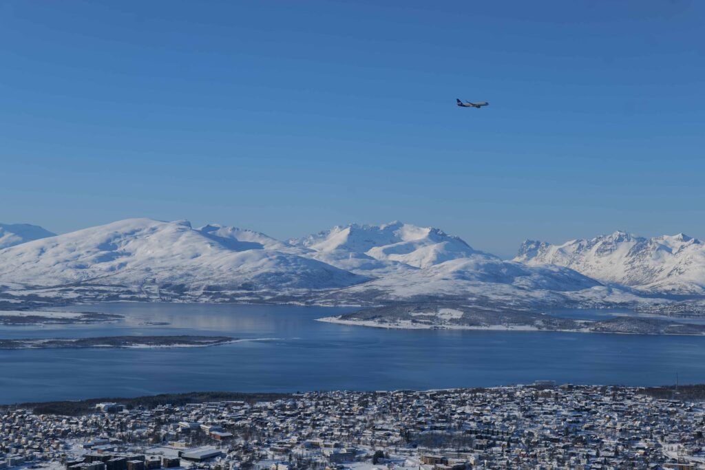 A plane flying over Tromsø
