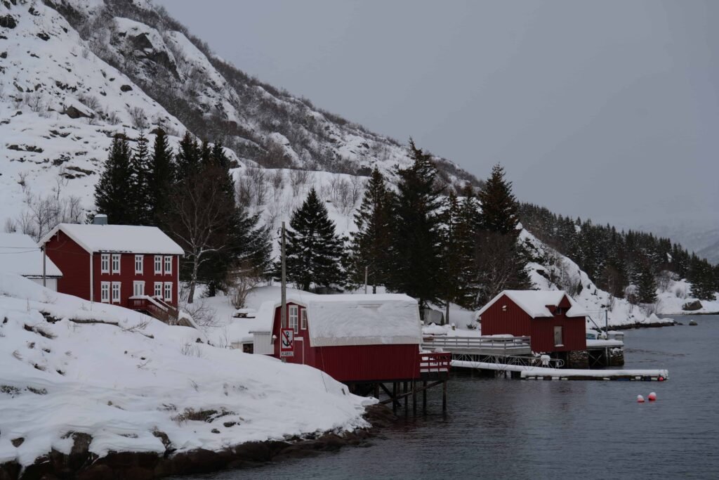 Sailing past remote cottages and fishing huts in the Raftsund!