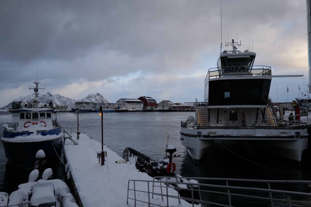 The boat docked in port, with its multiple outdoor decks
